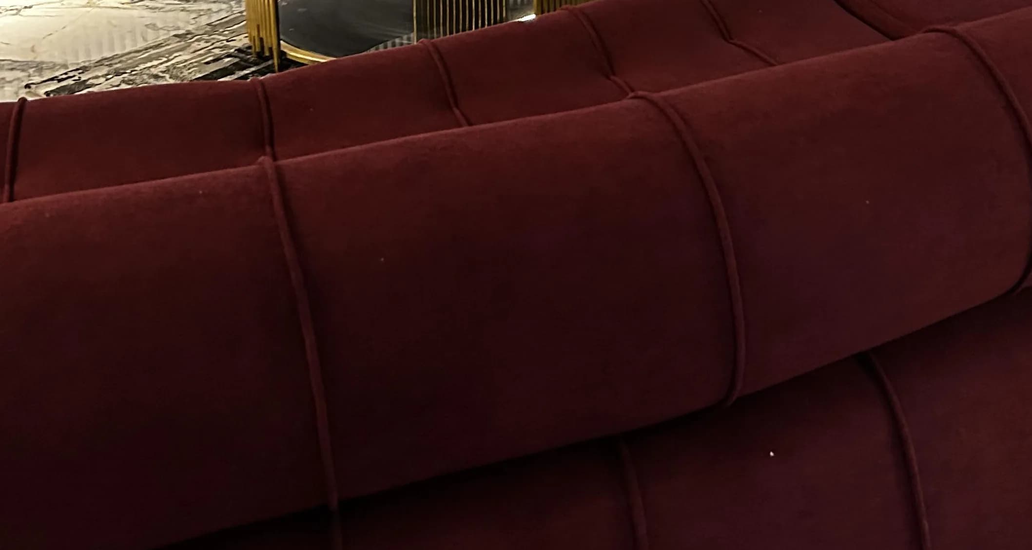 Close on the hand-filled channels of the Helix’s burgundy velvet bolster.